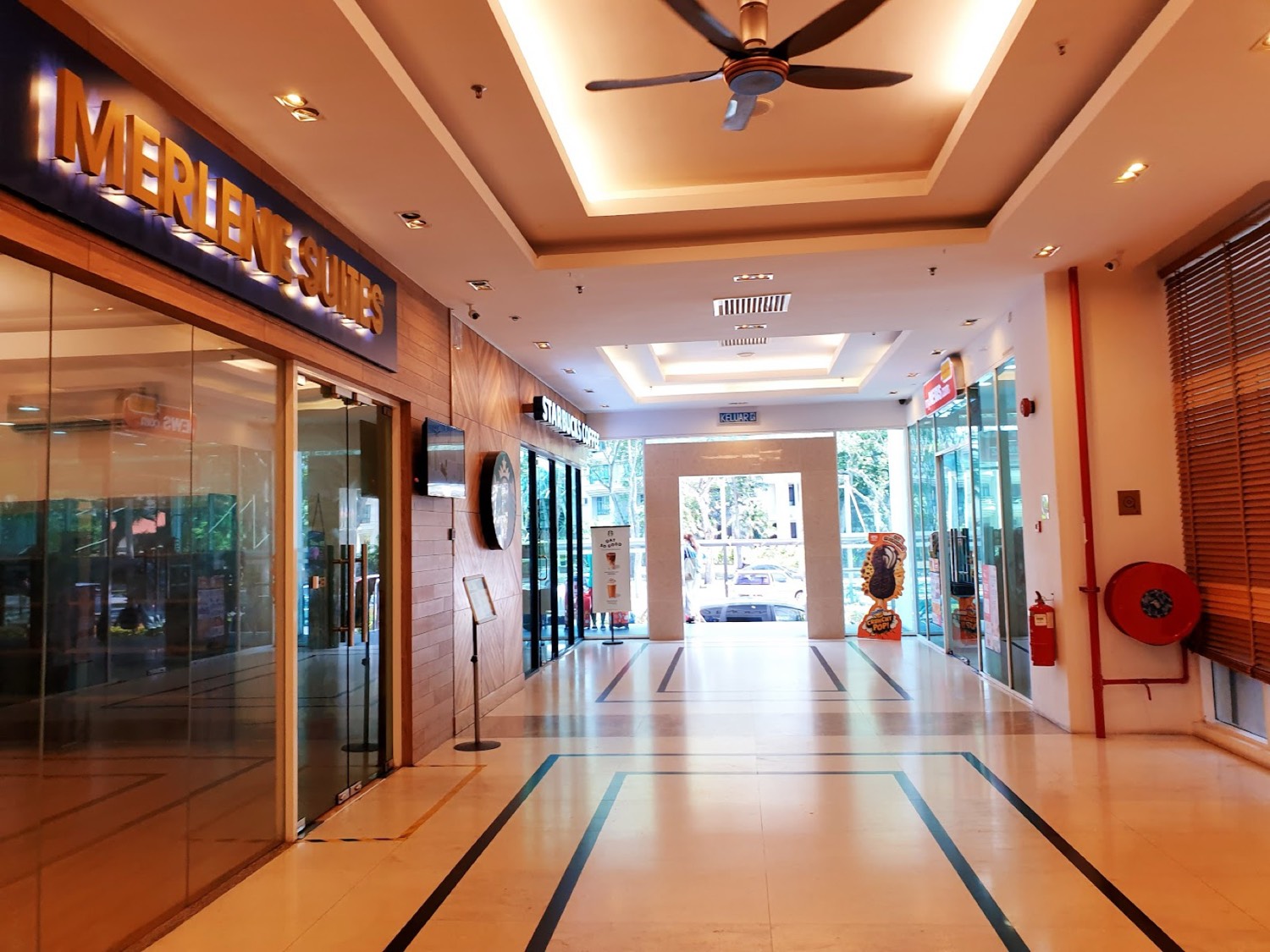 The polished interior arcade leading to Merlene Suites and Starbucks at Mansion One