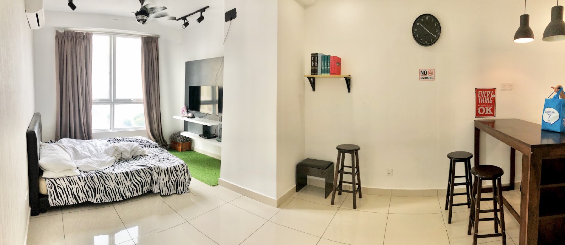 Studio suite with a double bed, smart TV and bar-stool counter at Merlene Suites